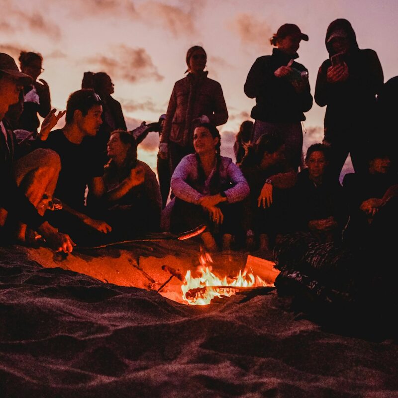 Friends partying on a Dubai beach at golden hour